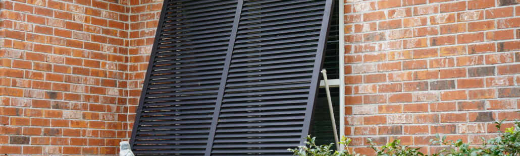 Bahama shutters installed on a Gulf Coast home