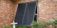 Bahama shutters installed on a Gulf Coast home